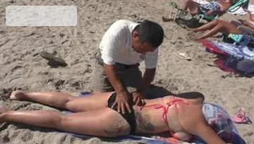 Busty massage at the beach